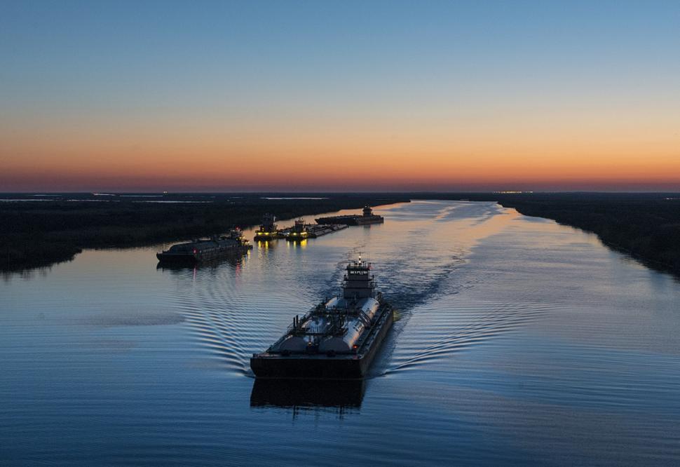 Free Image of Boat Traveling Down River at Sunset 