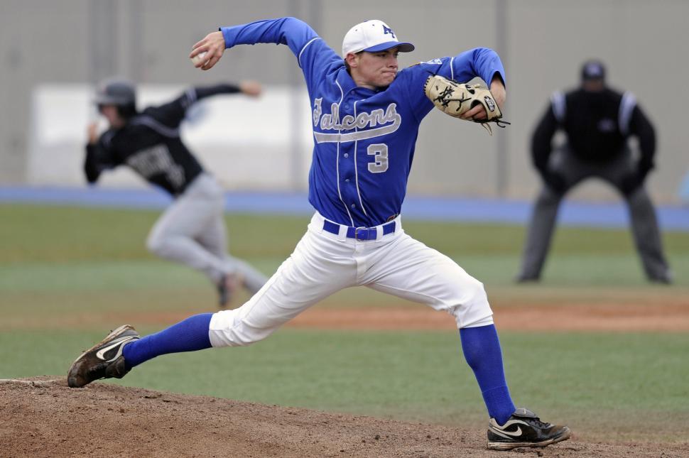 Free Image of Baseball Player Pitching Ball on Field 