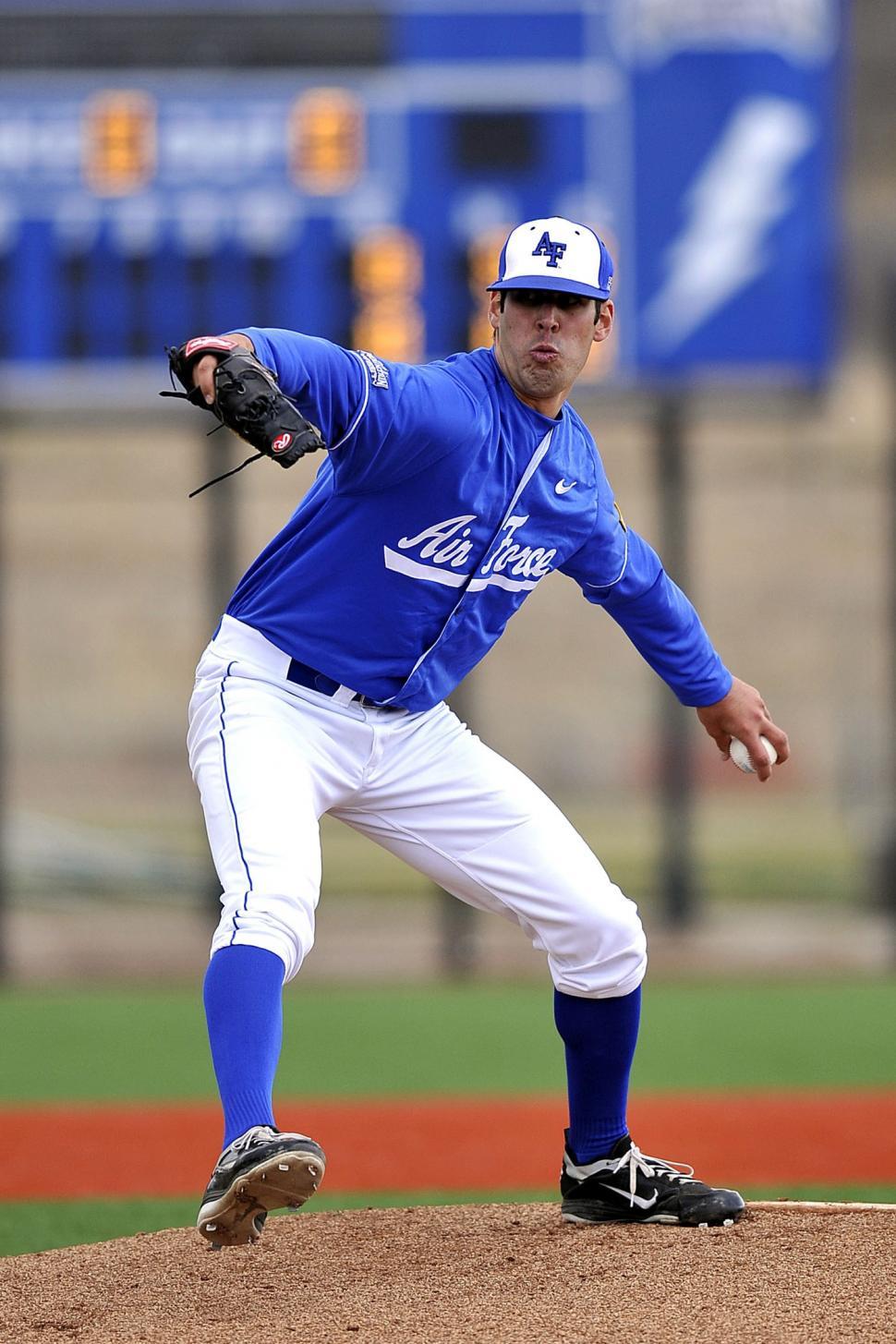 Free Image of Baseball Player Pitching Ball on Field 