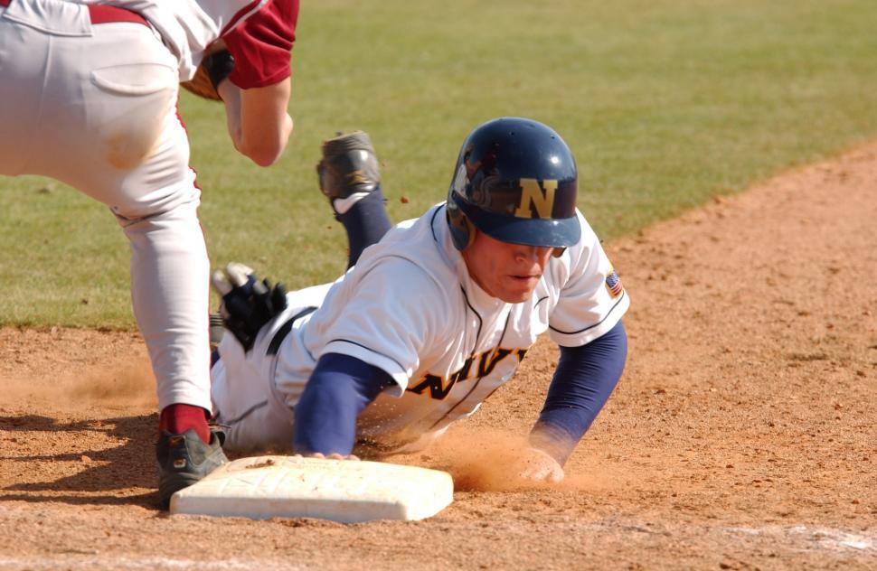 Free Image of Baseball Player Sliding Into Base During a Game 