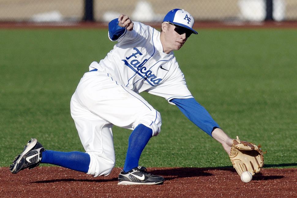 Free Image of Baseball Player Catching Ball on Field 