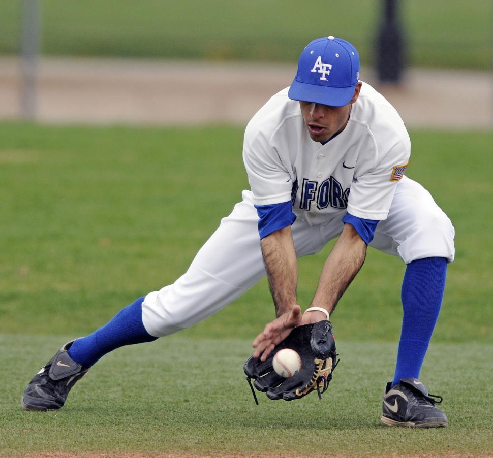 Free Image of Baseball Player Catching a Ball on a Field 