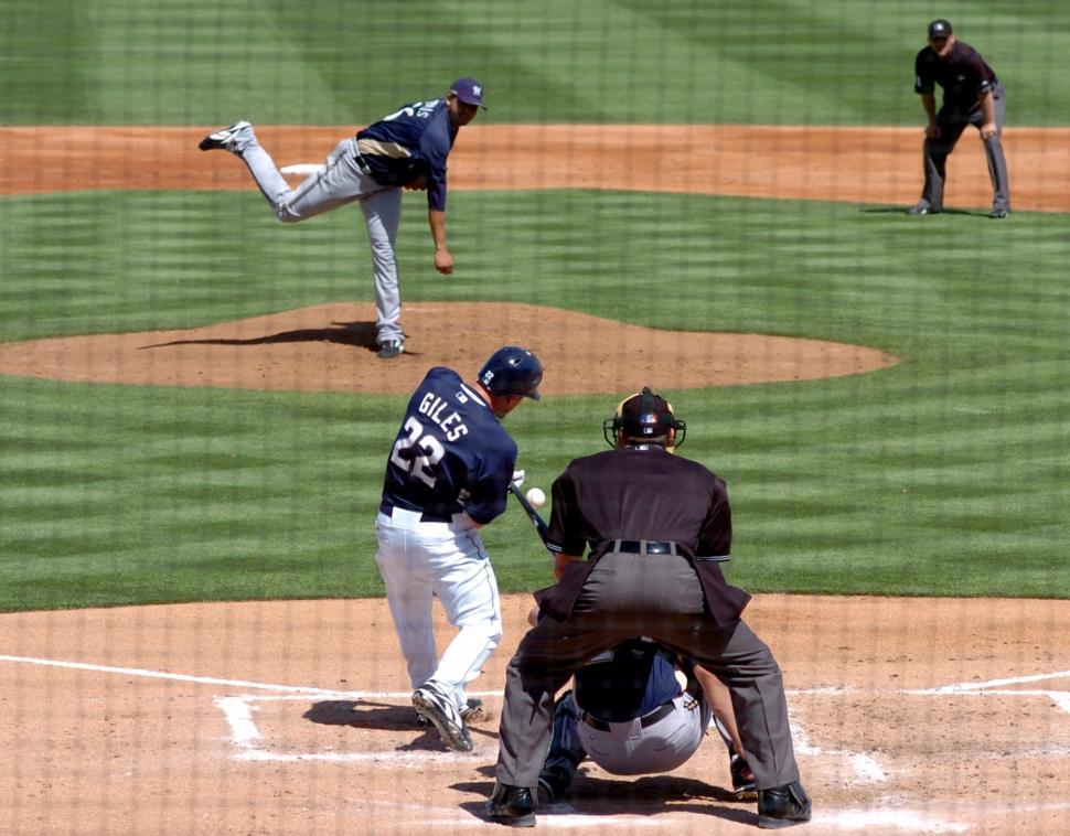Free Image of Group of Men Playing Baseball on Field 