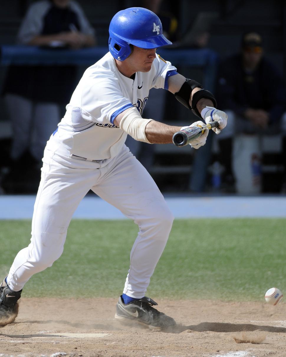 Free Image of Baseball Player Swinging Bat at Ball 