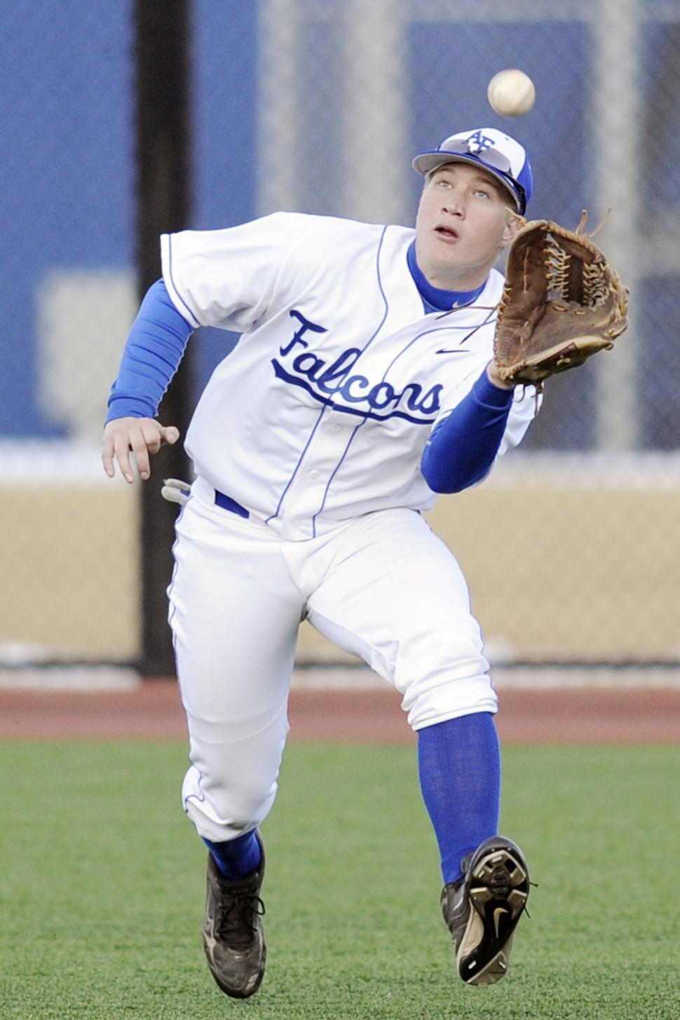 Free Image of Baseball Player Catching a Ball With His Glove 