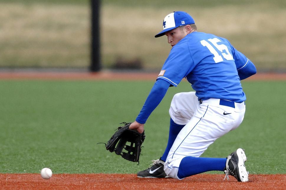 Free Image of Baseball Player Kneeling to Catch Ball 