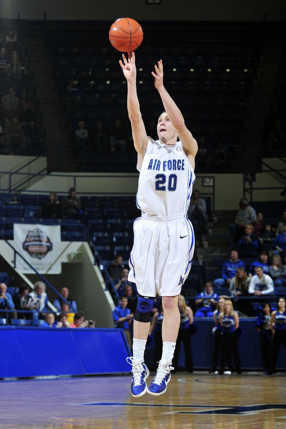 Free Image of Basketball Player Jumping to Dunk Ball 