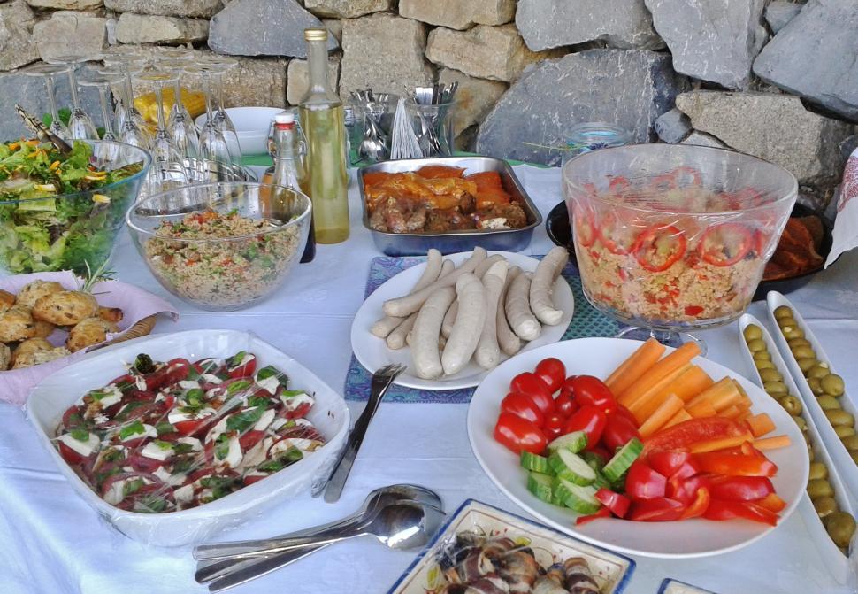 Free Image of Table Set With Plates of Food by Stone Wall 