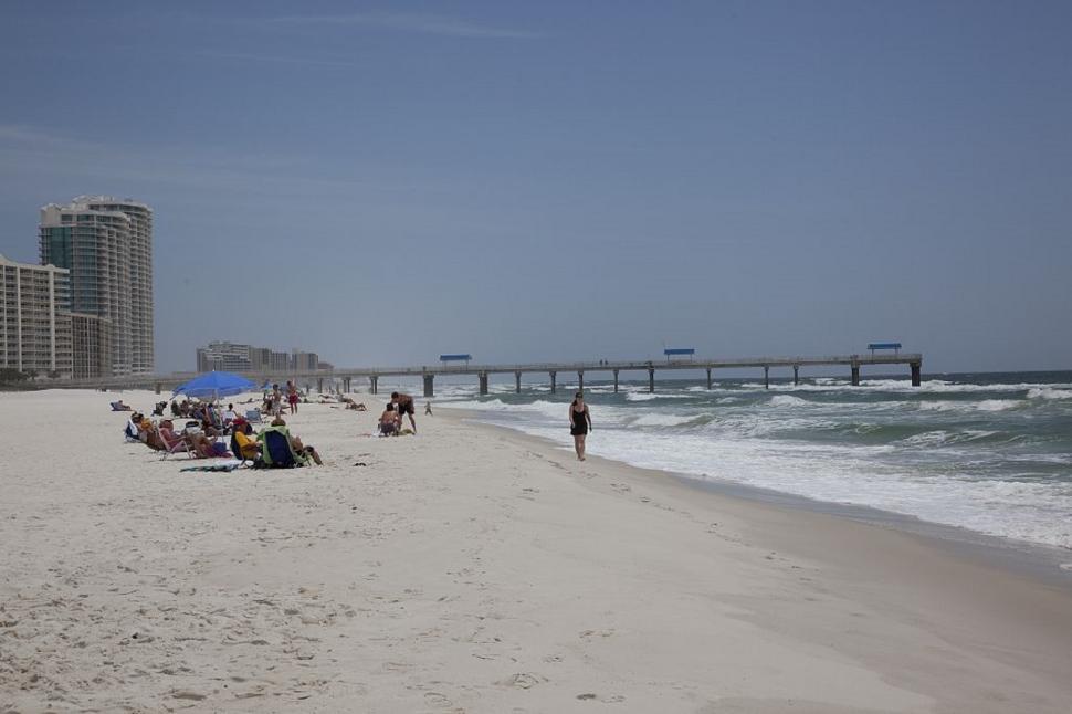 Free Image of Person Walking on Beach Beside Ocean 