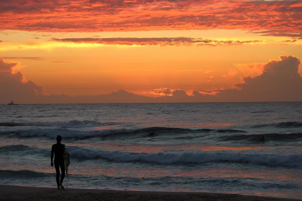 Free Image of Person Walking on Beach With Surfboard 
