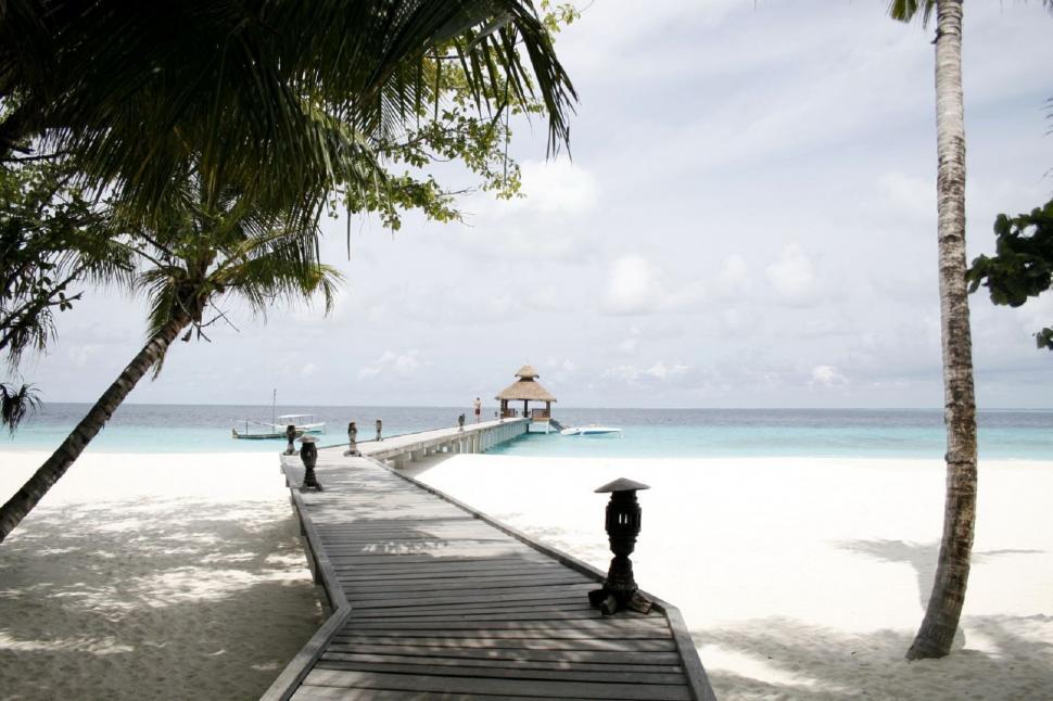 Free Image of Person Holding Umbrella on Beach 