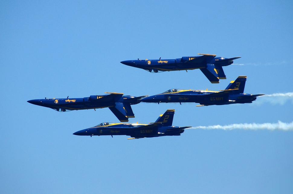 Free Image of Group of Fighter Jets Flying Through Blue Sky 