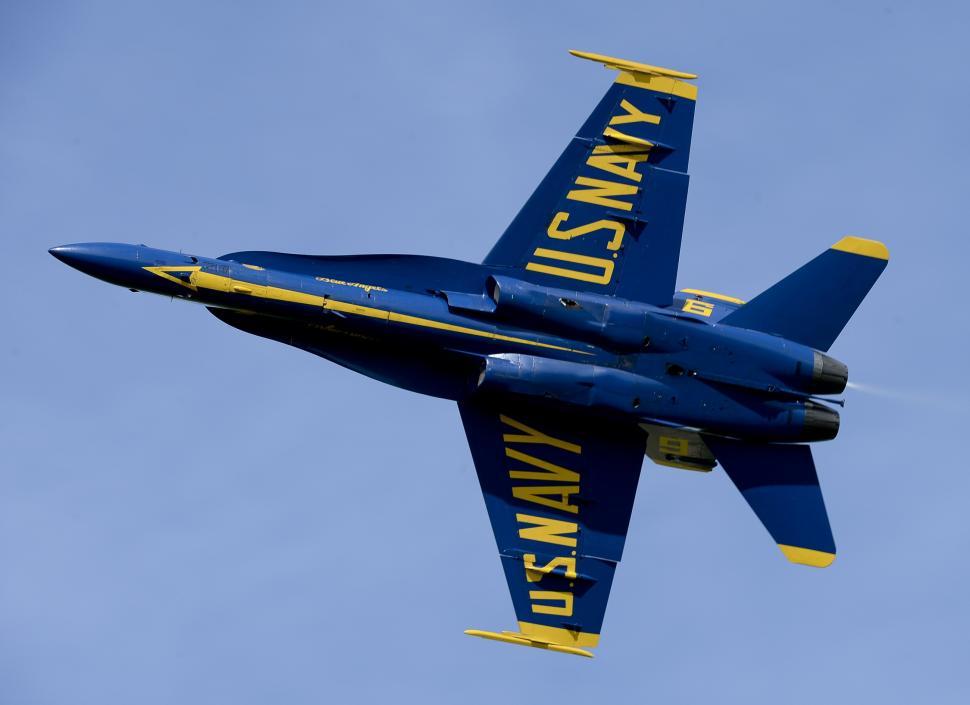 Free Image of Blue Fighter Jet Flying Through Blue Sky 
