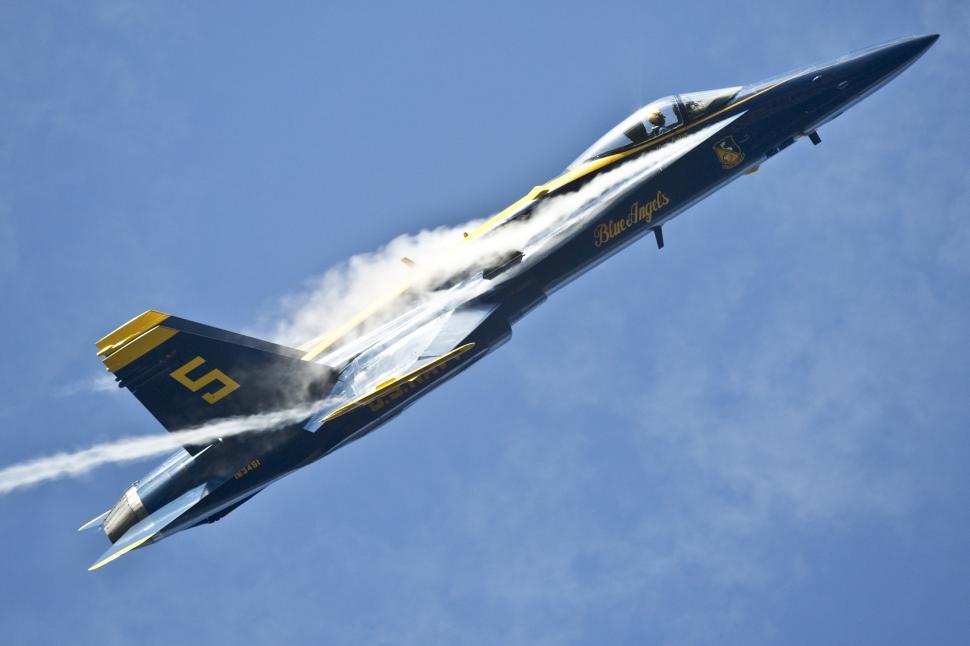 Free Image of Fighter Jet Flying Through Blue Sky 