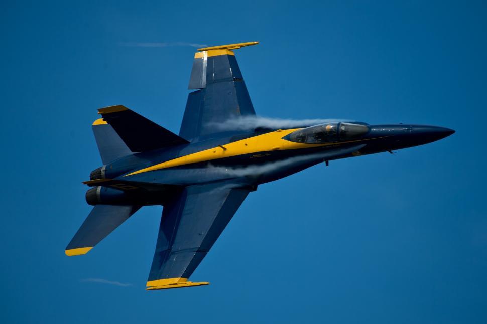 Free Image of Fighter Jet Flying Through a Blue Sky 