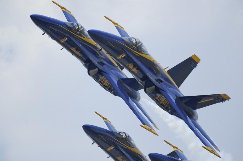 Free Image of Formation of Fighter Jets Flying Through Cloudy Sky 