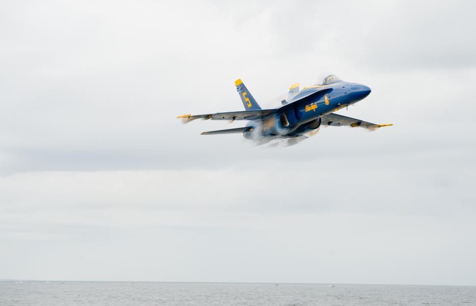 Free Image of Fighter Jet Flying Through Cloudy Sky 