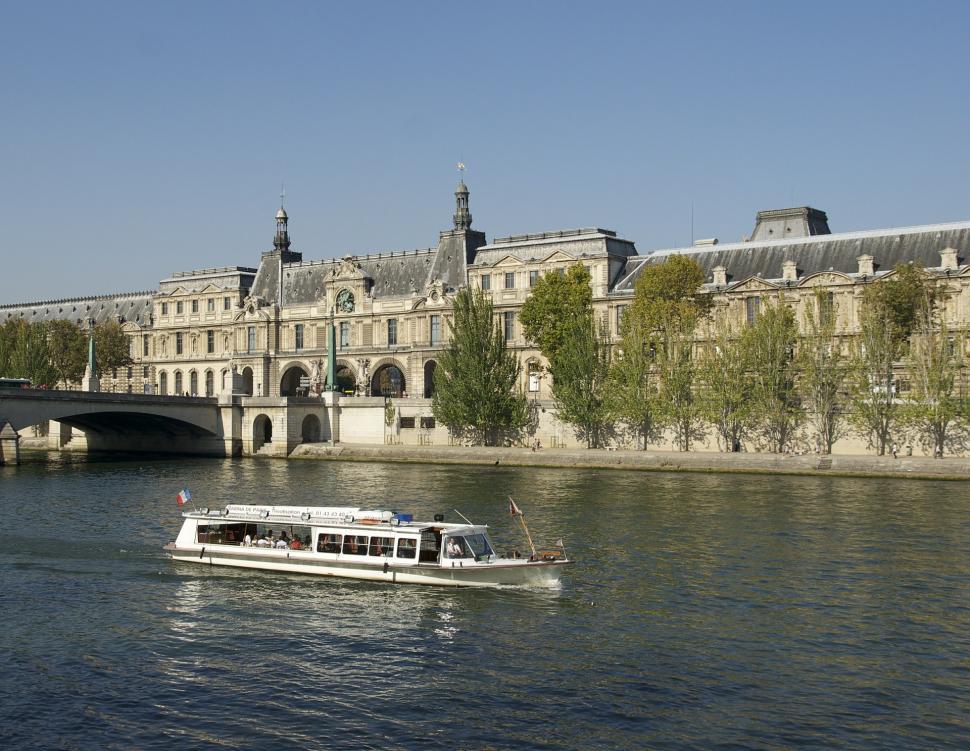 Free Image of White Boat Traveling Down River Next to Bridge 