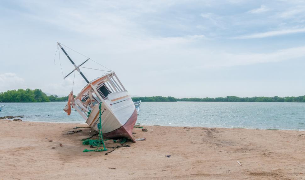 Free Image of Boat Resting on Sandy Beach 
