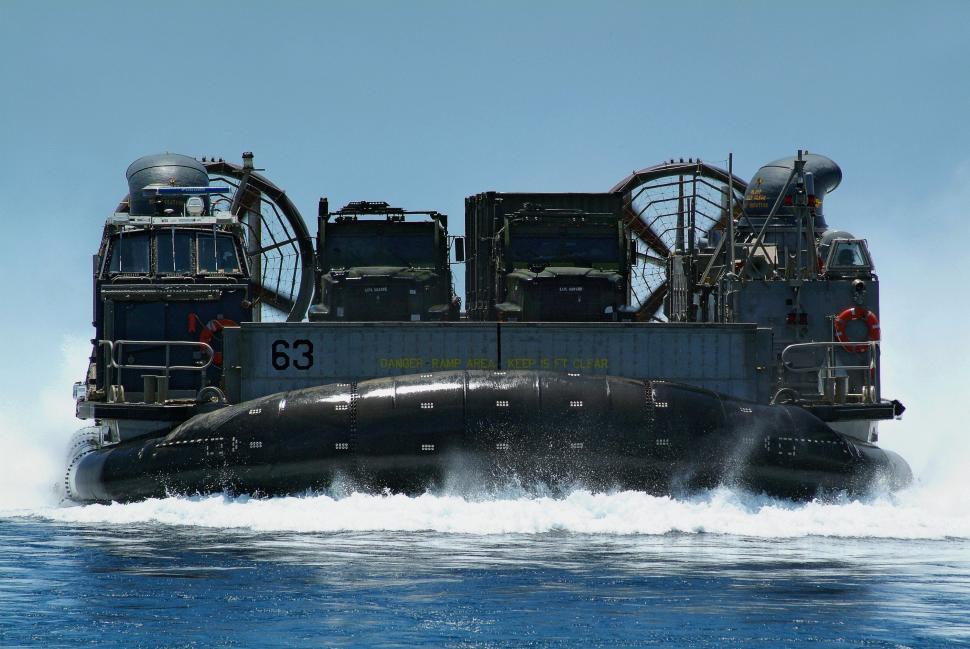 Free Image of Large Black Boat Floating on Body of Water 