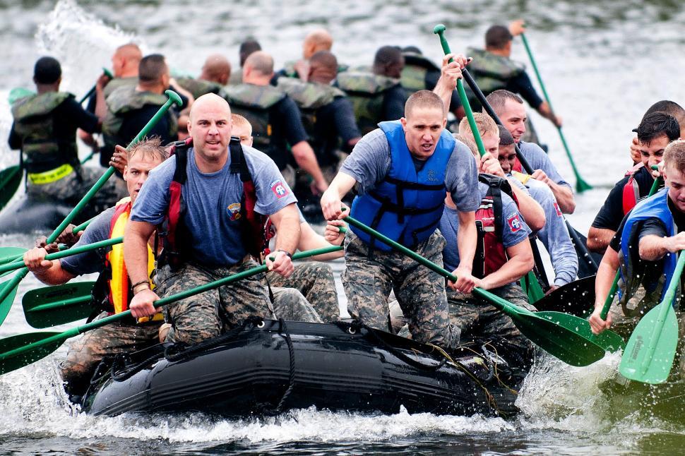 Free Image of Men Riding on a Raft Down a River 