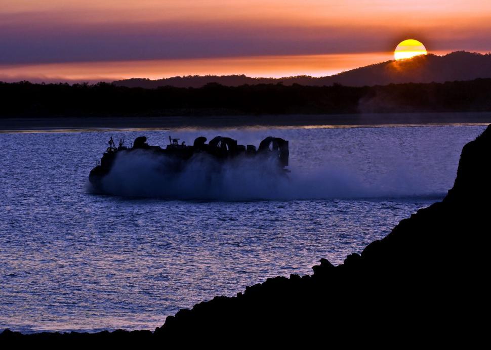 Free Image of Boat Traveling Across Water at Sunset 