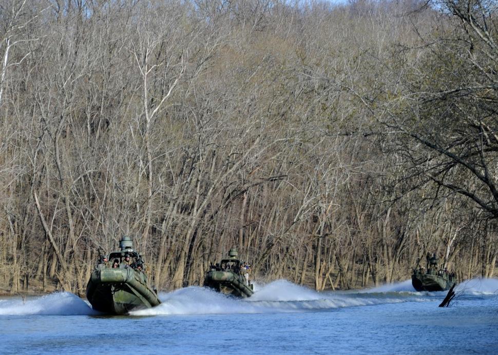 Free Image of Group of Boats Traveling Down River Next to Forest 