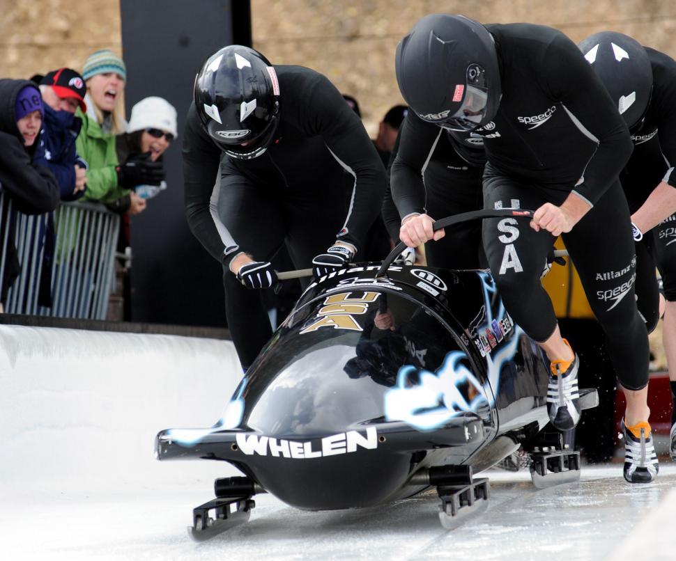 Free Image of Group of Men Riding on Top of a Sled 
