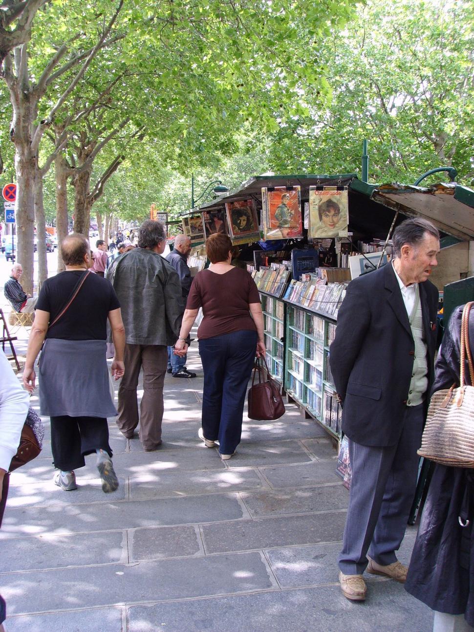 Free Image of Group of People Walking Down a Sidewalk 
