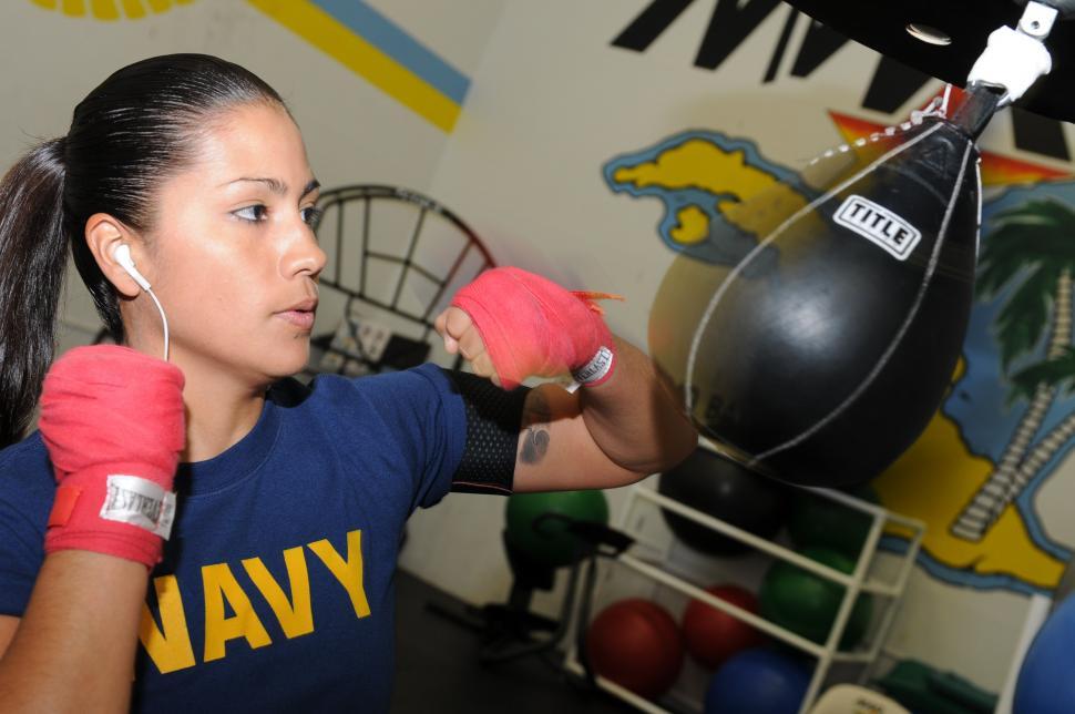 Free Image of Woman in Blue Shirt and Pink Boxing Gloves 