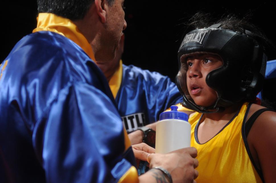 Free Image of Man in Blue and Yellow Uniform Talking to Woman 