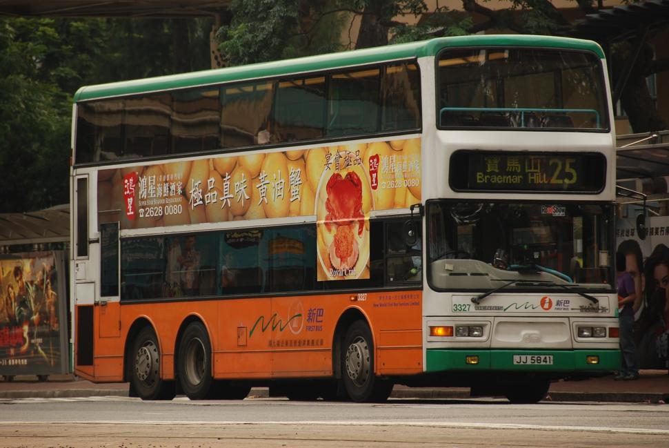 Free Image of Double Decker Bus Driving Down Street 