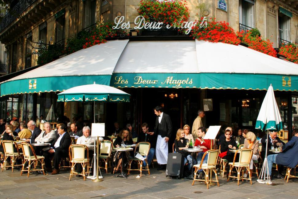 Free Image of Group of People Sitting Outside of a Restaurant 