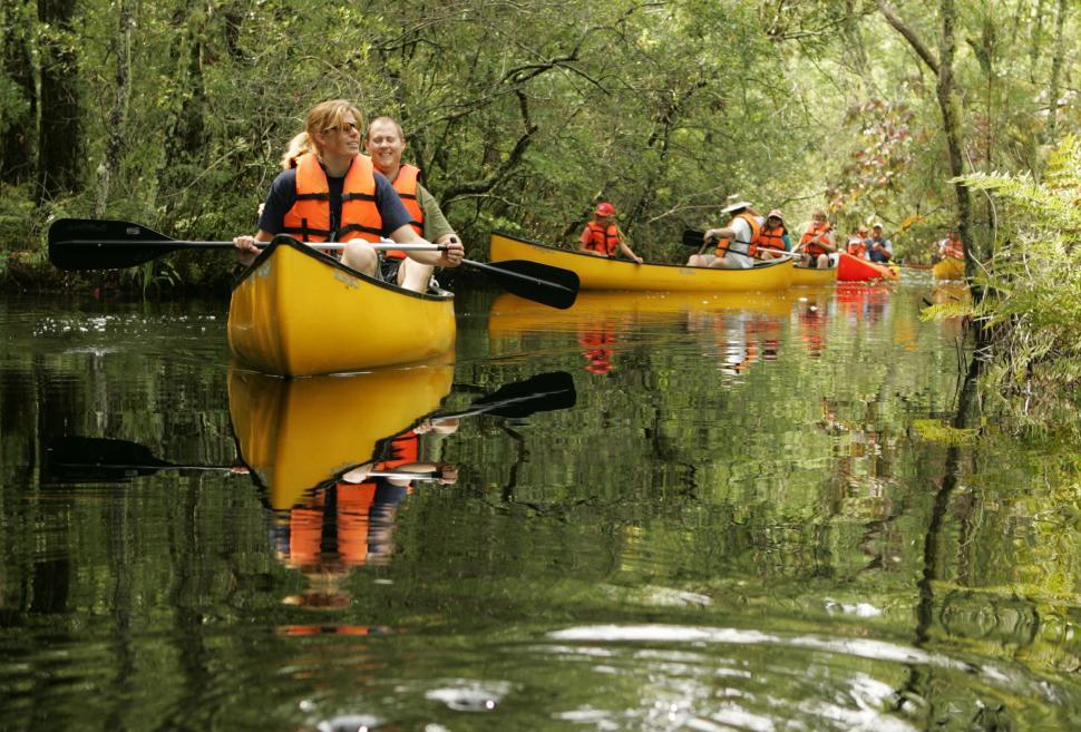Free Image of Group of People Riding on Top of a Yellow Boat 