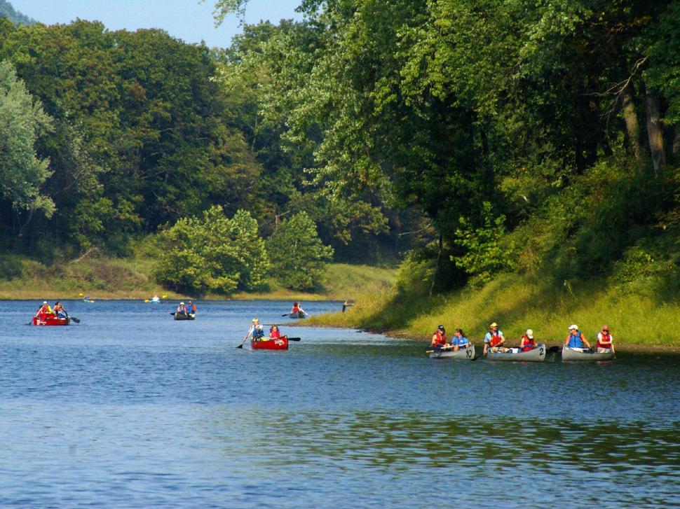 Free Image of Group of People Canoeing Down River 