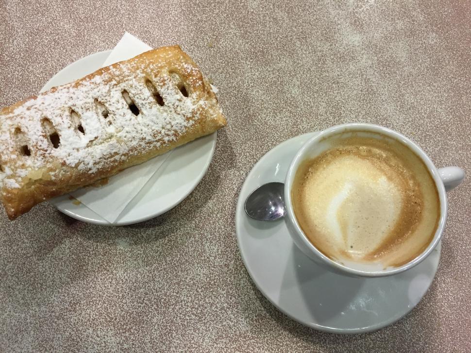 Free Image of A Cup of Coffee and a Pastry on a Saucer 