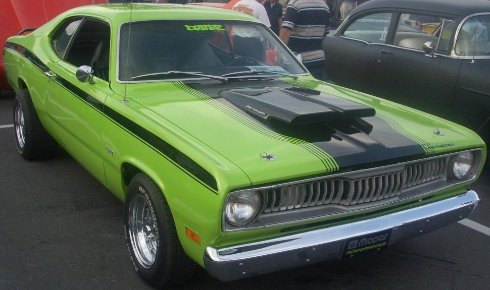Free Image of Green Car Parked Among Other Cars in Parking Lot 