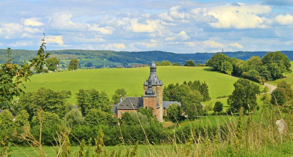 Free Image of Large Building on Lush Green Hillside 