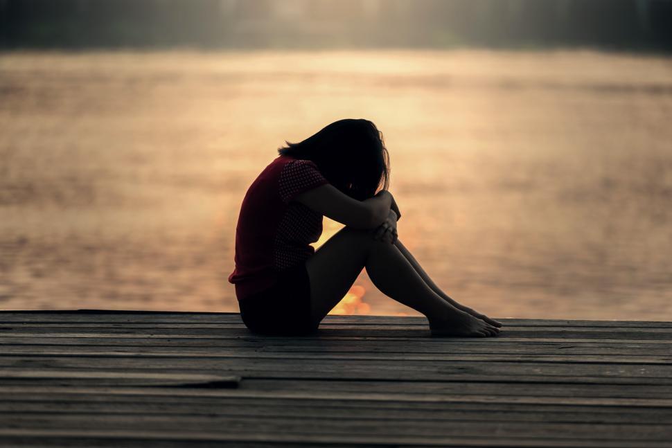 Free Image of Person Sitting on Dock by Water 