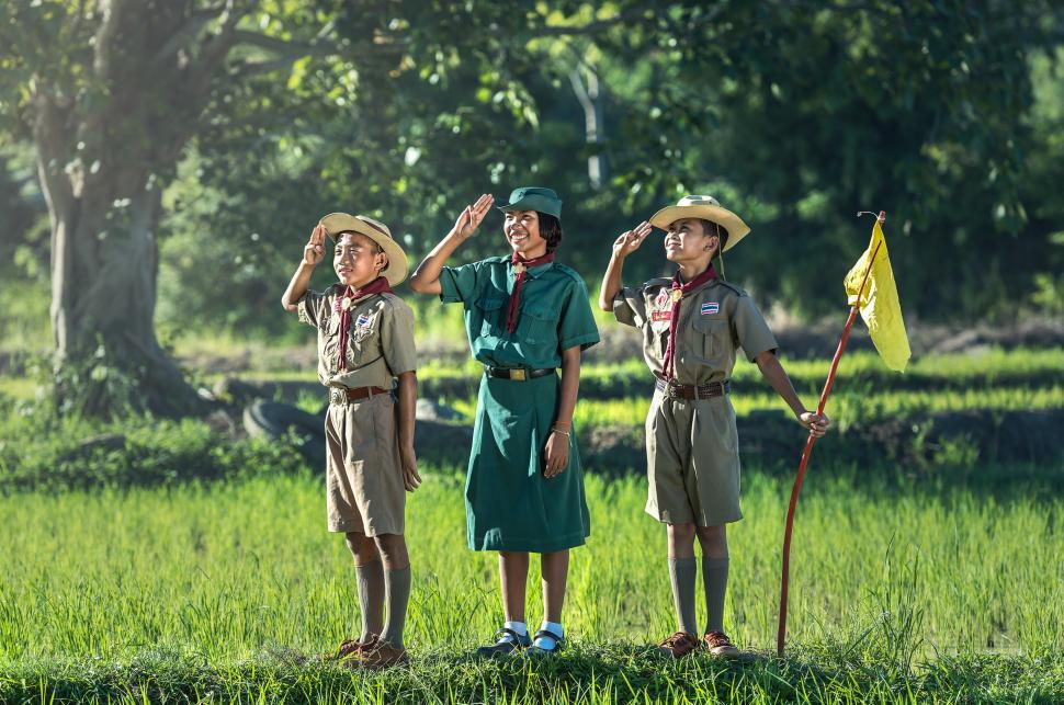 Free Image of Group of People Standing on Top of Lush Green Field 