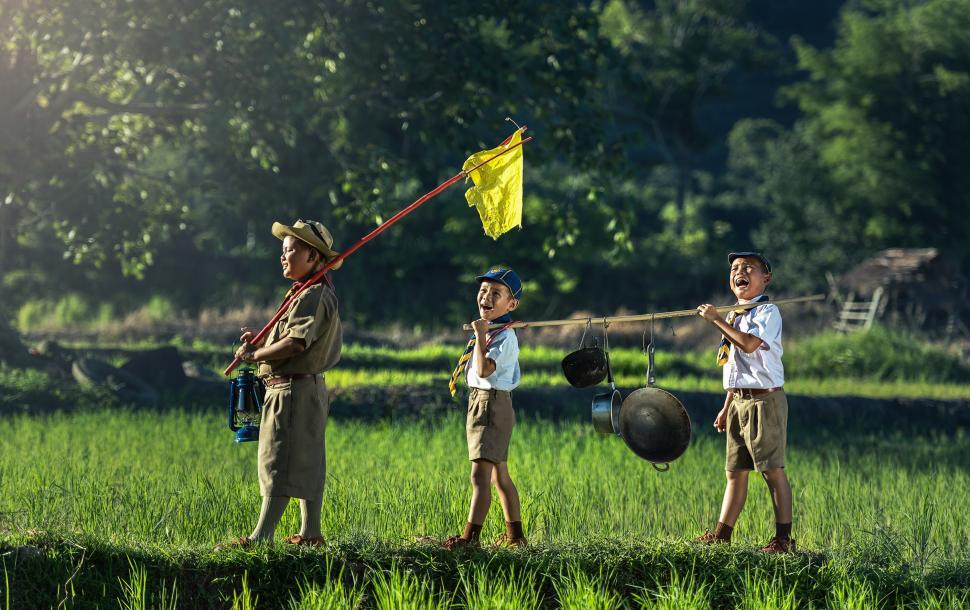 Free Image of Group of People Standing on Top of Lush Green Field 