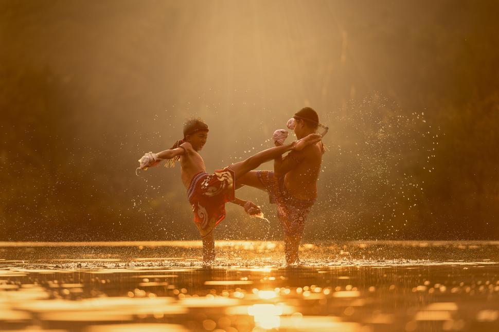 Free Image of People Standing on Top of a Body of Water 