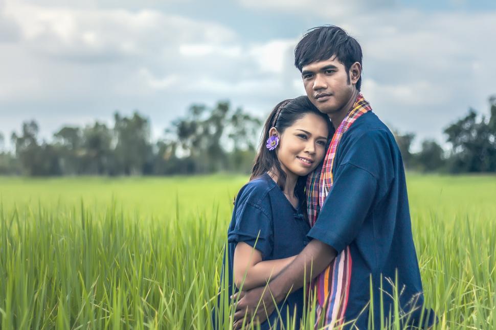 Free Image of Man and Woman Standing in a Field 