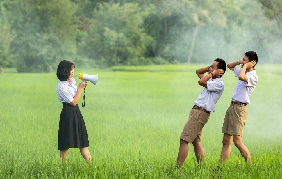 Free Image of Group of People Standing on Top of Lush Green Field 