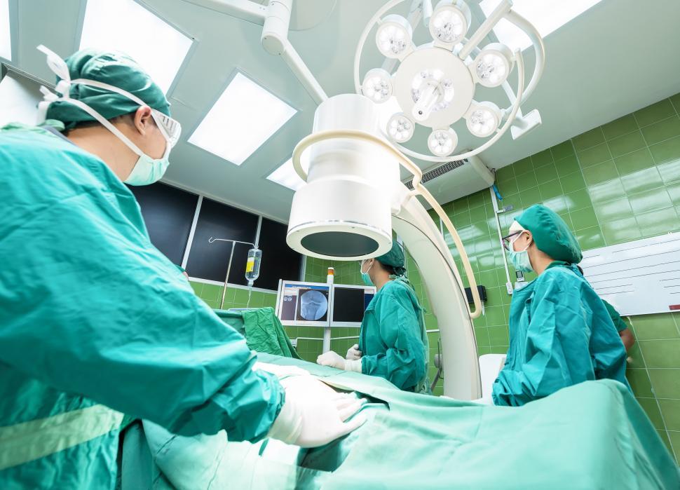 Free Image of Group of Doctors Performing Surgery in Operating Room 