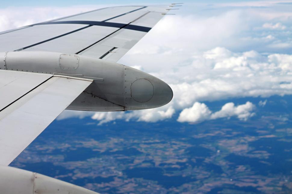 Free Image of Wing of an Airplane Flying Above the Clouds 