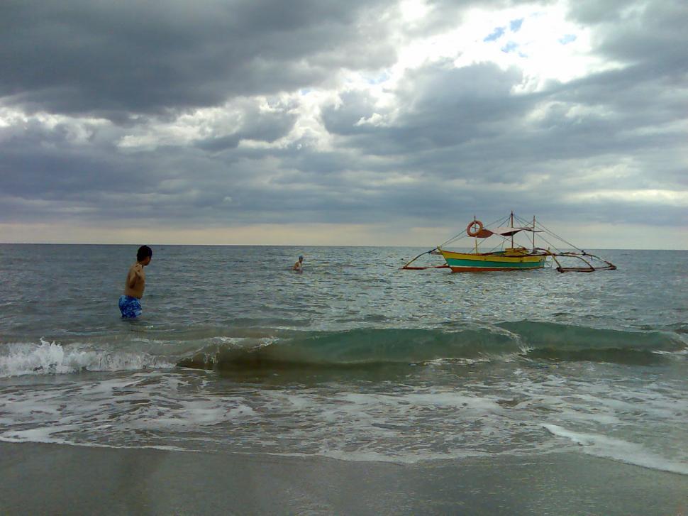 Free Image of Wading by the gentle waves 