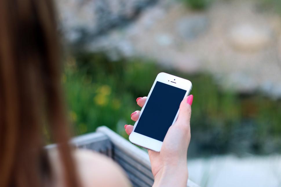 Free Image of Woman Holding Smart Phone in Hand 