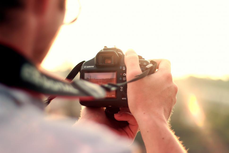 Free Image of Man Holding Camera Up to Take a Picture 