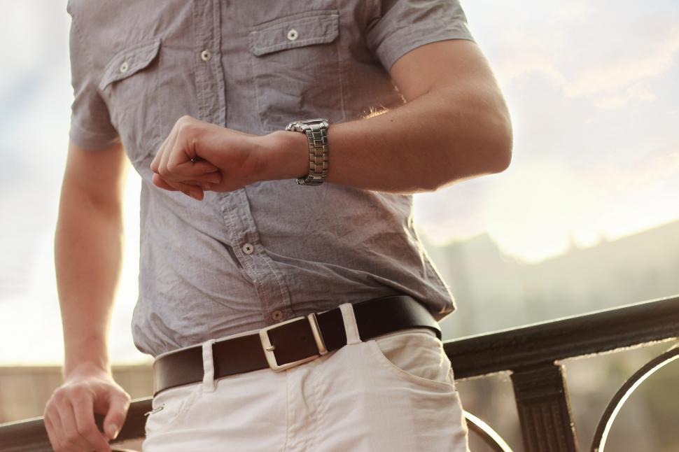 Free Image of Man in Gray Shirt and White Pants 